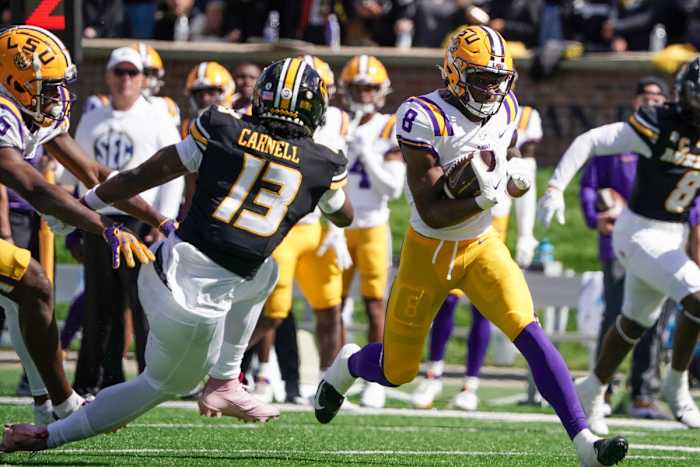 Oct 7, 2023; Columbia, Missouri, USA; LSU Tigers wide receiver Malik Nabers (8) runs the ball as Missouri Tigers defensive back Daylan Carnell (13) defends during the second half at Faurot Field at Memorial Stadium. Mandatory Credit: Denny Medley-USA TODAY Sports